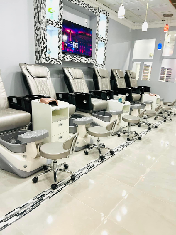 Pedicure spa chairs in a row with damask accent panels